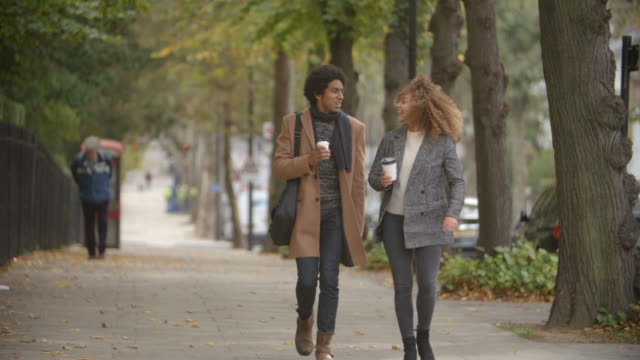 Stylish-Couple-Walk-On-Fall-Street-In-City-In-Slow-Motion