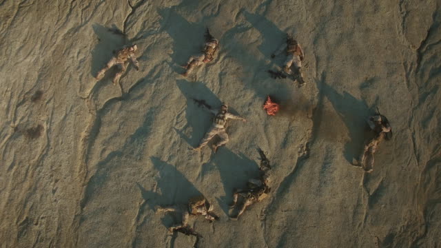 Flying-over-Group-of-Dead-Soldiers-in-Desert-Area.-Zooming-In.