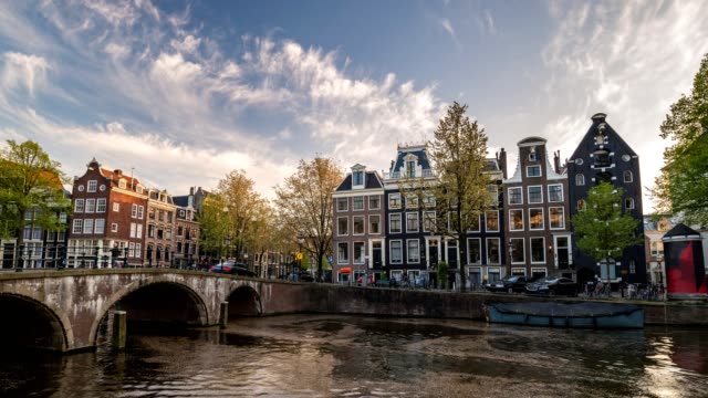 Amsterdam-city-skyline-sunset-timelapse-at-canal-waterfront,-Amsterdam,-Netherlands,-4K-Time-Lapse