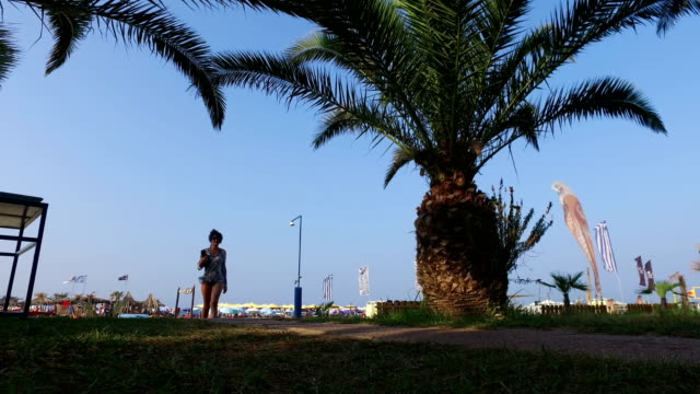Das-Mädchen-Fuß-am-Strand-unter-einer-Palme