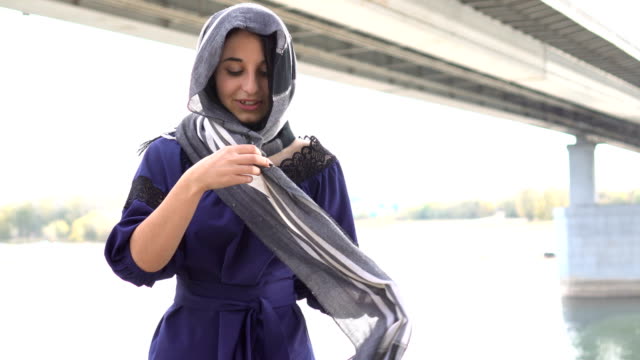 Middle-eastern-girl-putting-on-own-hijab