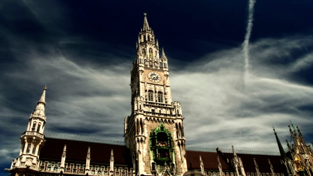 Hyper-time-lapse-moving-on-Marienplatz-square-with-Munich-Rathaus-historical-city-town-hall-on-cloudy-day-Germany-Bavaria-timelapse-hyperlapse-travel-Europe-wanderlust