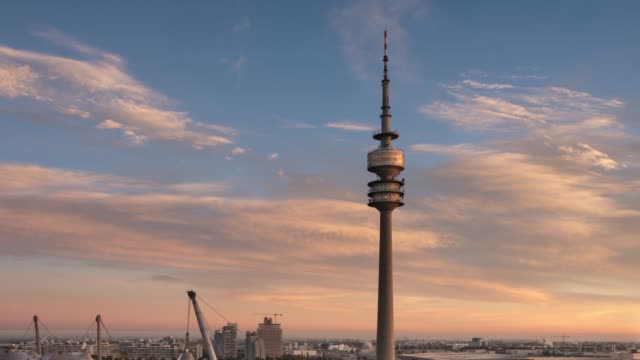 4-K-Time-Lapse-Video-of-Olympic-Park-and-Olympic-Tower-with-zooming-out-transition,-Munich,-Bavaria,-Germany