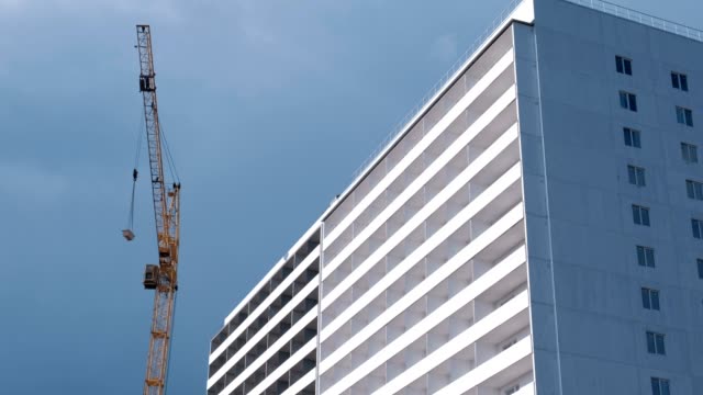 Construction-of-a-multi-storey-building.-House-and-construction-crane-on-sky-background.