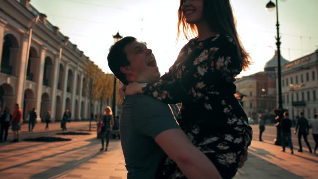 Young-couple-dancing-at-sunset-street
