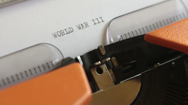Close-up-footage-of-a-person-writing-WORLD-WAR-III-on-an-old-typewriter