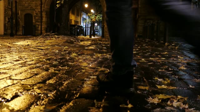 Man-Walking-Empty-Cobbled-Street-in-London-at-Night