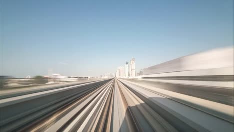 Time-lapse-journey-on-the-modern-driverless-Dubai-elevated-Rail-Metro-System,-running-forward-alongside-the-Sheikh-Zayed-Road