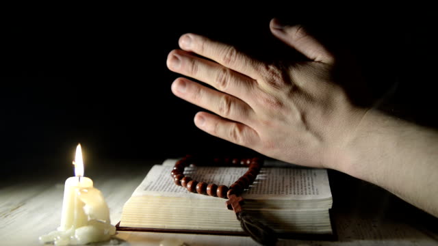 praying-hands-over-a-holy-book