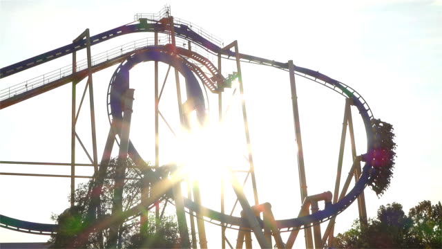 SLOW-MOTION:-Extreme-roller-coaster-ride-at-golden-sunset