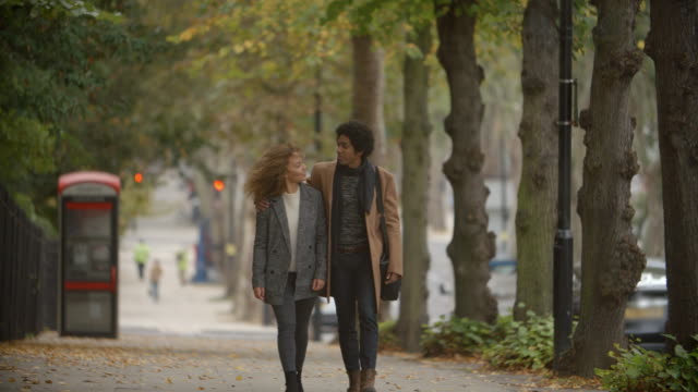 Romantic-Couple-Walk-On-Fall-Street-In-City-In-Slow-Motion