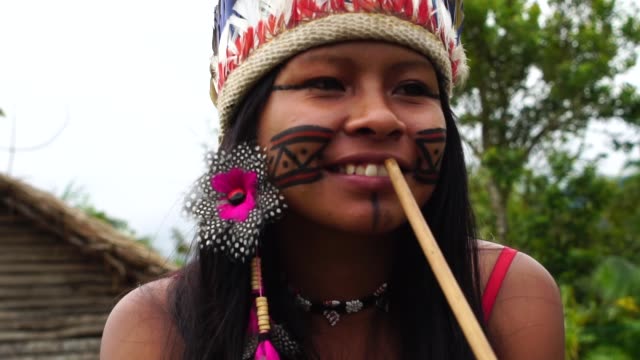 Indigenous-Woman-Smoking-Pipes-in-a-Tupi-Guarani-Tribe,-Brazil