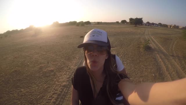Couple-taking-a-selfie-in-a-camel-riding-in-desert