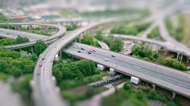 Aerial-view-of-a-complex-motorway-road-junction-with-traffic-moving-and-tilt-shift-effect