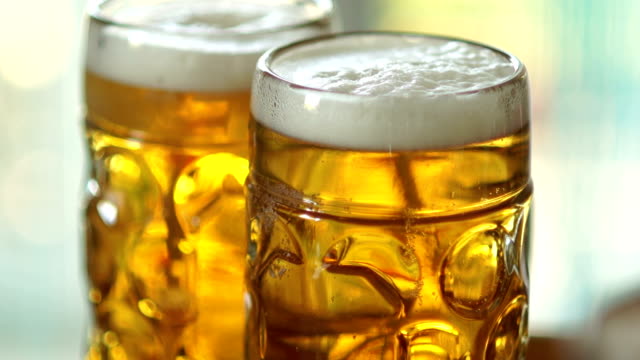 Two-full-glasses-of-cold-beer.-Close-up,-visible-foam-and-air-bubbles-in-the-glass.-Glass-of-glasses-fogged-up