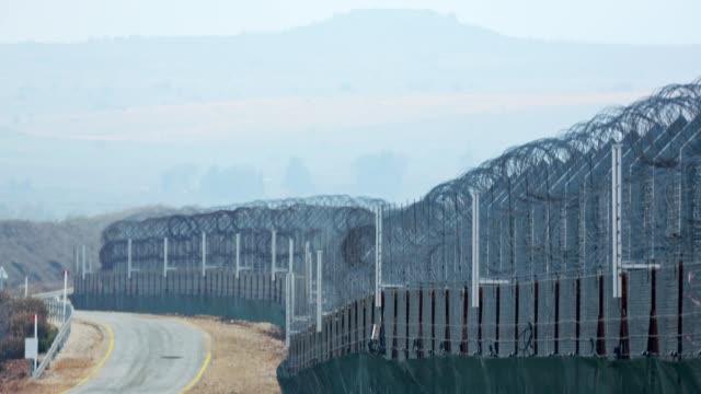 Border-of-Syria-and-Israel.-Tall-fences-with-military-posts-and-UN-soldiers