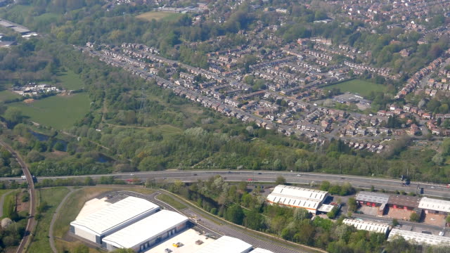Aerial-view-of-Stockport-from-colorful-football-pitches-to-wastewater-plant