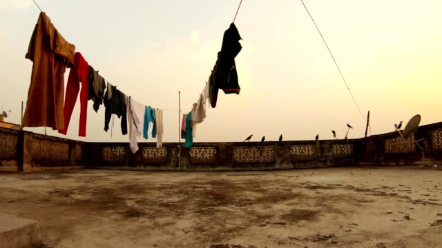 old-threadbare-roof-drying-clothes-crows-jump-Kolkata