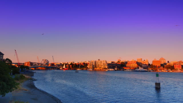 Ultra-Wide-Pan-Shot-of-the-City-of-Victoria-BC-Inner-Harbour,-Summer-Sunset