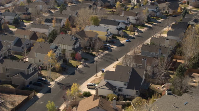 AERIAL,-CLOSE-UP:-Suburban-village-with-expensive-row-houses-on-sunny-fall-day