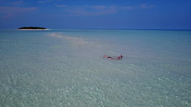 v03977-fliegenden-Drohne-Luftaufnahme-der-Malediven-weißen-Sandstrand-2-Personen-junges-Paar-Mann-Frau-romantische-Liebe-auf-sonnigen-tropischen-Inselparadies-mit-Aqua-blau-Himmel-Meer-Wasser-Ozean-4k