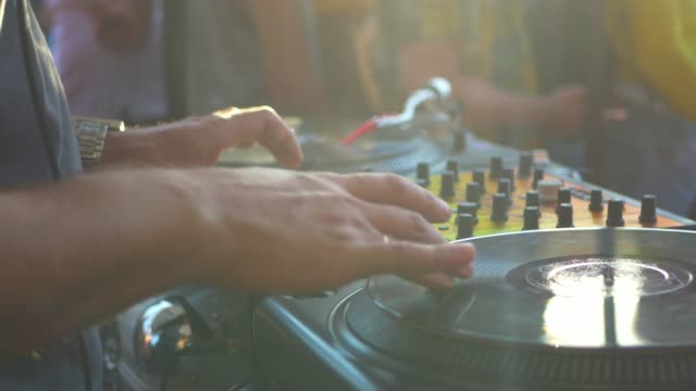 close-up-dj-hand-scratching-vinyl-record-on-turntable-on-a-party