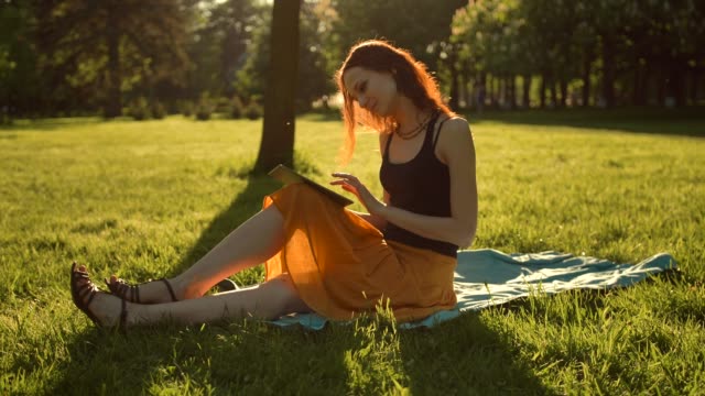 Handsome-sexy-female-using-tablet-computer-outdoors
