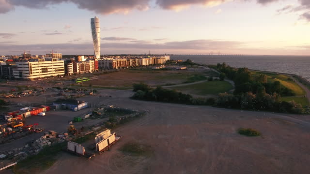 Aerial-view-of-Malmo-city-buildings-at-sunset.-Industrial,-construction-area