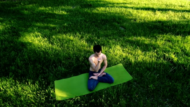 Young-bare-chested-man-doing-yoga
