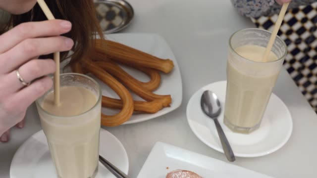 Horchata-with-fartons-and-churros-in-Valencian-cafe,-Spain