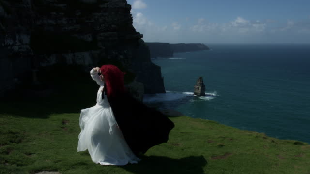 4k-Shot-of-a-Redhead-Queen-on-Cliffs-of-Moher-View-in-Ireland