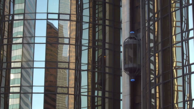 Futuristic-modern-business-building-glass-elevator-lift-moving-up