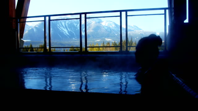 Woman-relaxing-in-swimming-pool