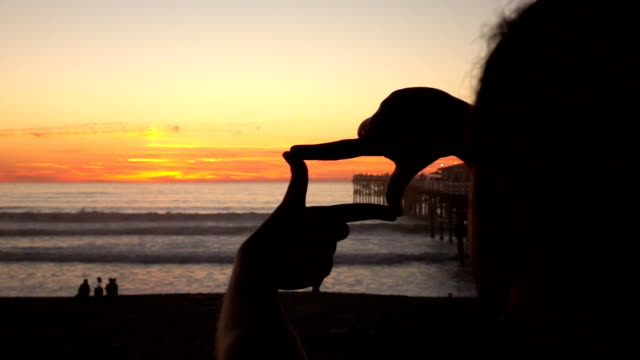 Framing-sunset-by-the-ocean-in-slow-motion