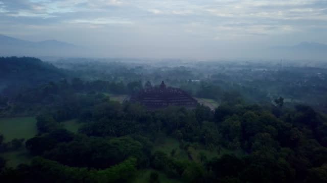 Tiro-de-drone-de-vista-aérea-del-templo-de-Borobudur-en-Java-al-amanecer,-viajes-Indonesia-religión-drone-concepto-4K-de-resolución