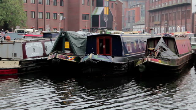 Close-Up-Pan-of-Narrow-Boat-Barges-Docked-in-Canal-Harbour