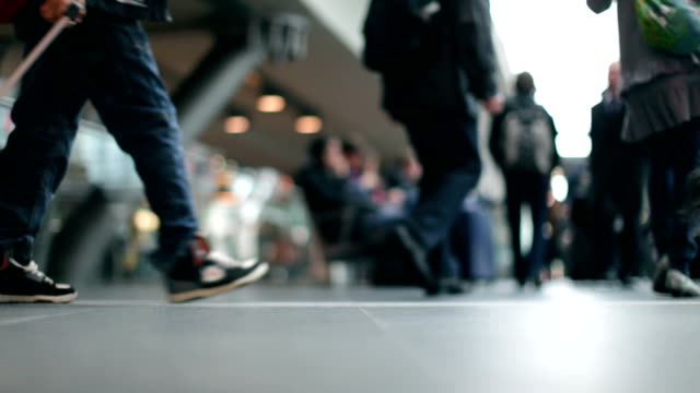 Passengers-with-luggage-case-at-a-modern-Station-and-Bokeh