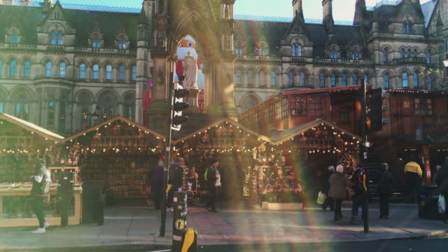 MANCHESTER,UK---DECEMBER-16,-2016.-Shot-of-shoppers-at-the-Christmas-market-in-front-of-the-Manchester-Town-Hall-on-Albert-Square.-December-16,-2016