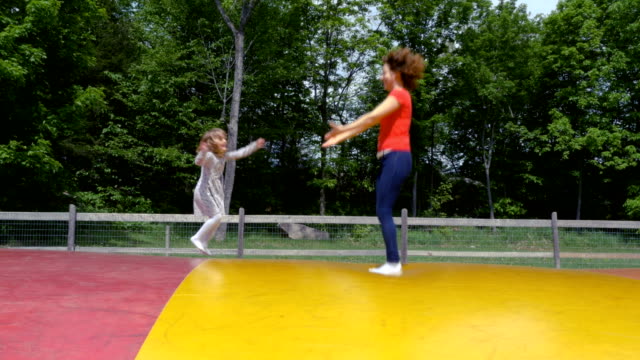 Mother-and-Daughter-Playing-on-a-Jumping-Pillow