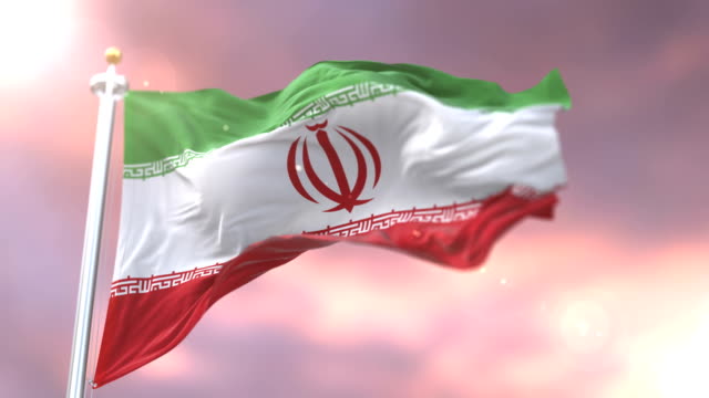 Flag-of-Iran-waving-at-wind-in-slow-at-sunset,-loop