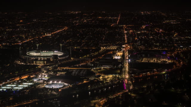 Melbourne`s-skyline-from-high-vantage-point-showing-stadiums,-roads-and-train-lines.-Time-lapse.