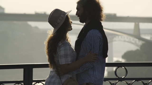 Embracing-and-kissing-couple-on-high-top-bridge