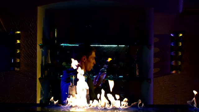 Professional-bartender-making-cool,-amazing-tricks-with-two-bottles-standing-behind-the-bar,-catching-on-elbow,-throwing-up,-fire-show,-slow-motion
