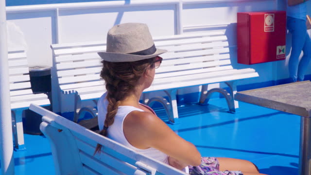 Young-attractive-woman-relaxing-on-cruise-ship