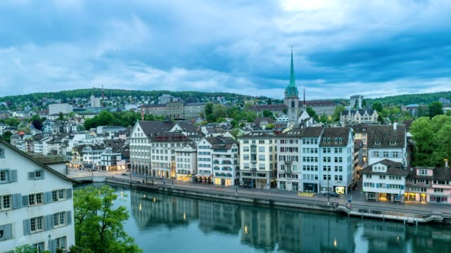 Zurich-city-skyline-night-to-day-timelapse-view-from-Lindenhof,-Zurich,-Switzerland,-4K-Time-lapse