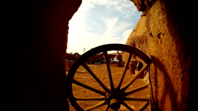 an-old-wooden-wheel-in-the-doorway,-a-courtyard-in-an-Arab-village,-next-to-the-border-between-Turkey-and-Syria