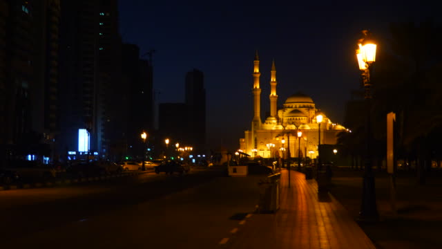Camera-motion-from-mosque-to-crescent.-Dark-arabian-night.-Mosque-illuminated-with-gold-lights.-Lanterns-at-path-pedestrian-road.