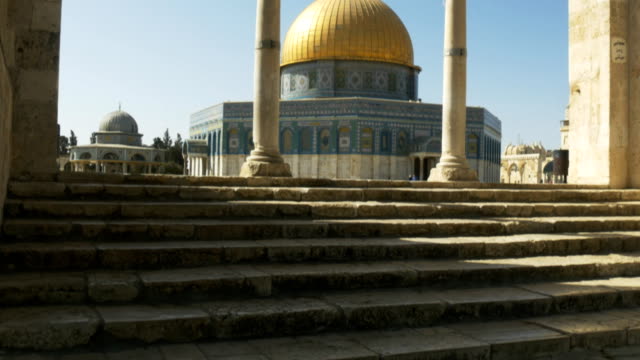 tilt-up-shot-of-dome-of-the-rock-framed-by-several-arches-in-jerusalem