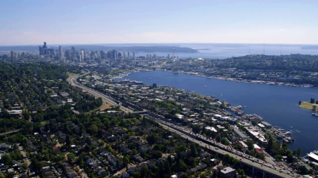 Heli-View-Over-Seattle-Waterfront-Community-with-Skyline-Background