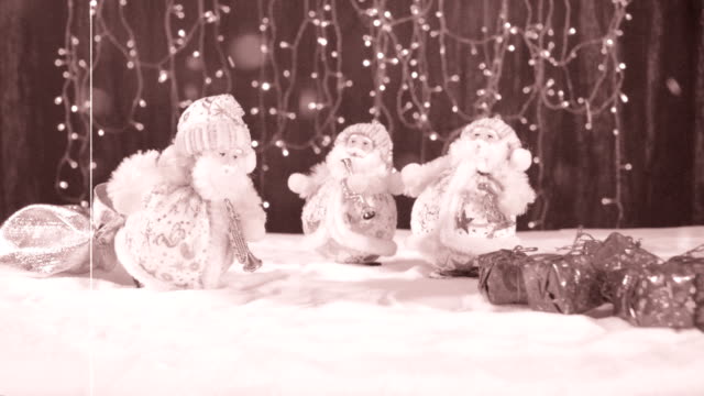 Three-funny-musicians-Santa-Claus-with-their-gifts-are-having-fun,-dancing,-celebrating-and-congratulating-in-the-whirling-snow-and-at-the-end-the-inscription-Happy-New-Year.